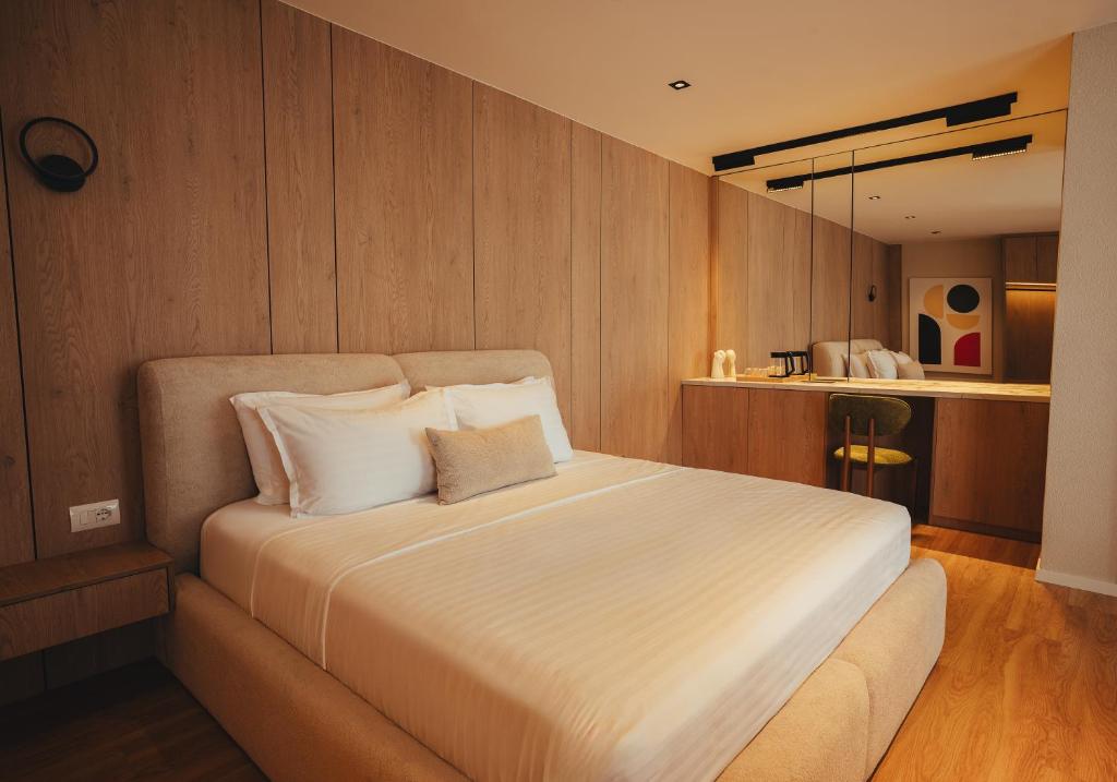 Master king bed against wood-panel wall