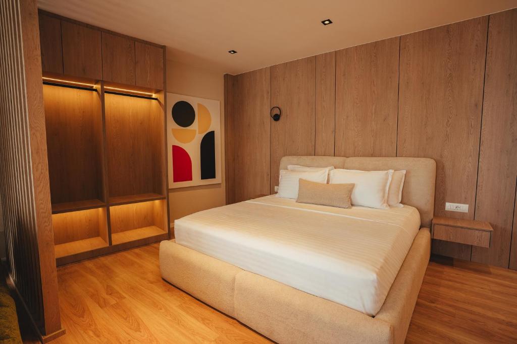 Master bed with wardrobe niche and geometric artwork