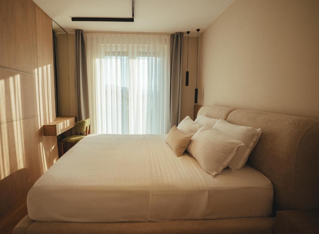 Bed and desk area lit by soft window light