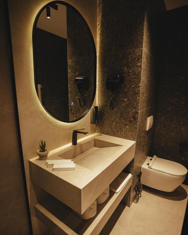 Bathroom vanity with round backlit mirror