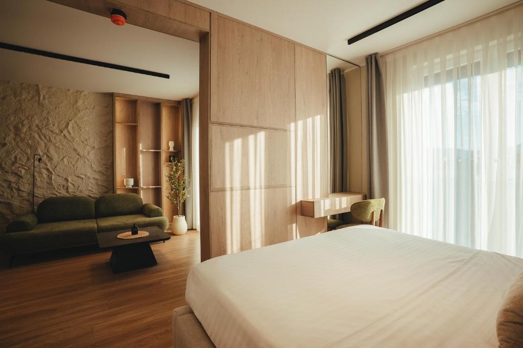 Deluxe Double Room — full view with bed and lounge